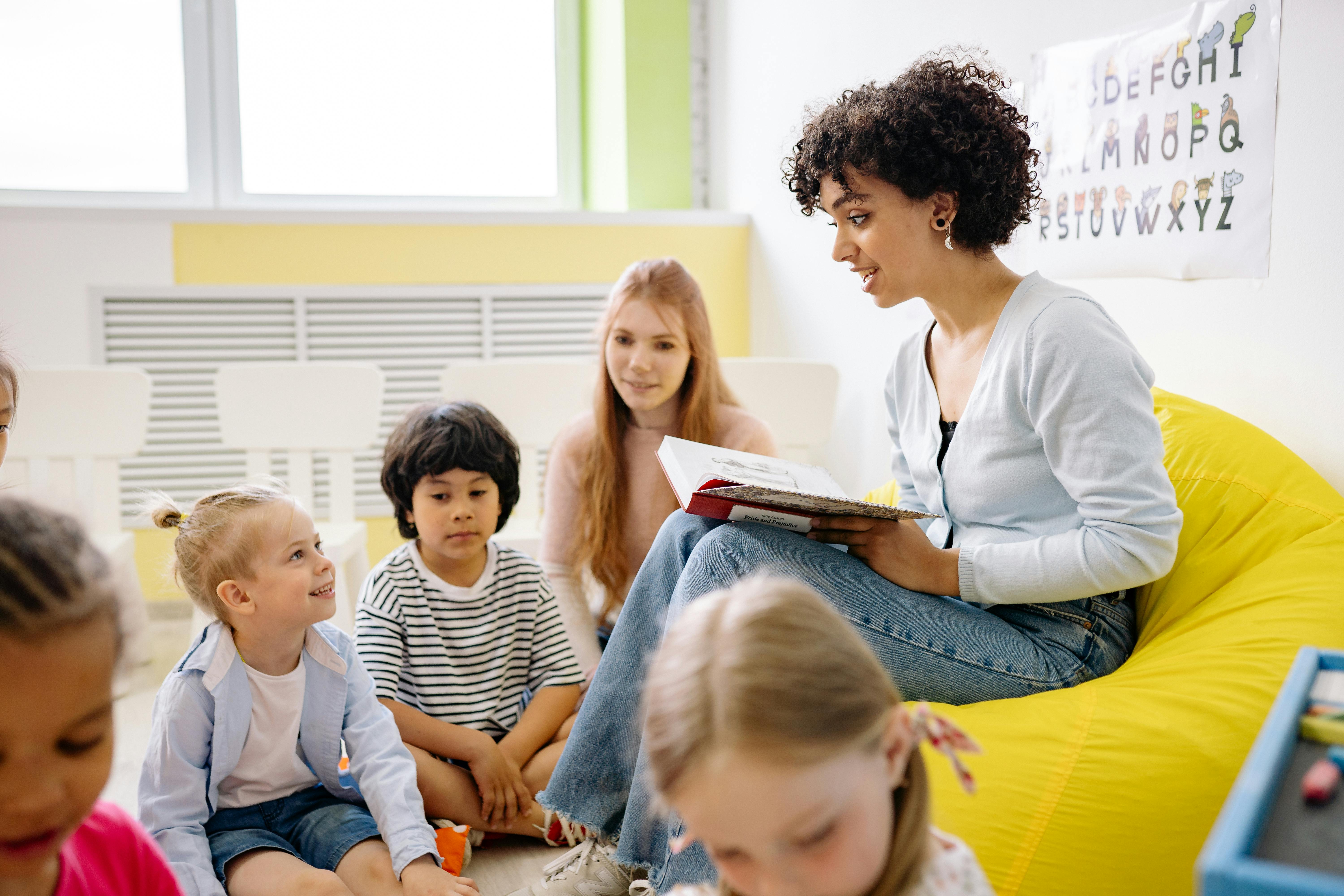 Teacher reading to young students in a classroom